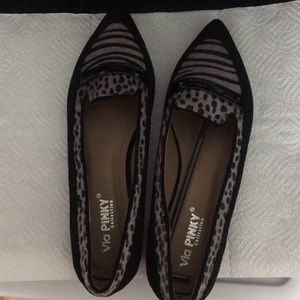 Pair of flat shoes with low black heel.